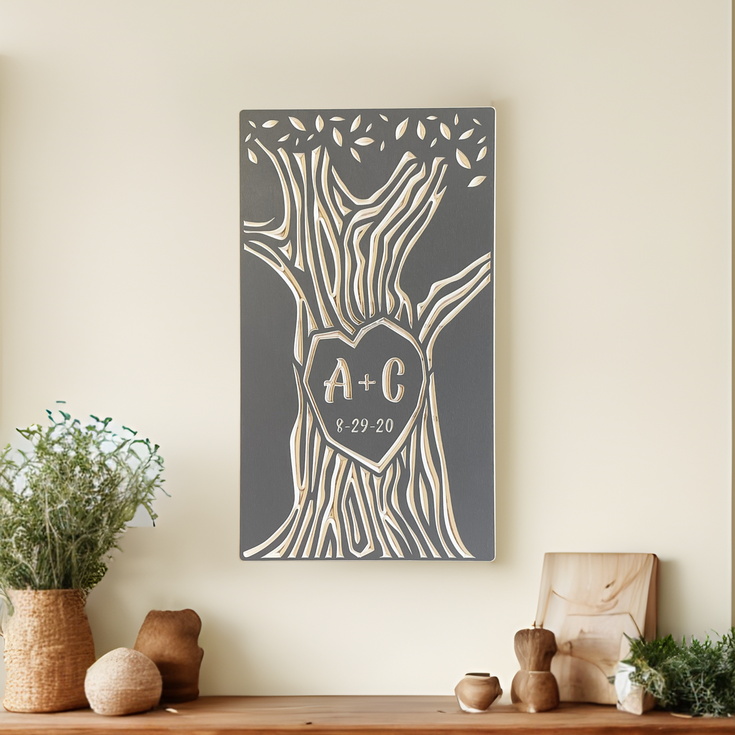Decorative wall art personalized with initials on a neutral wall above a wooden console table.