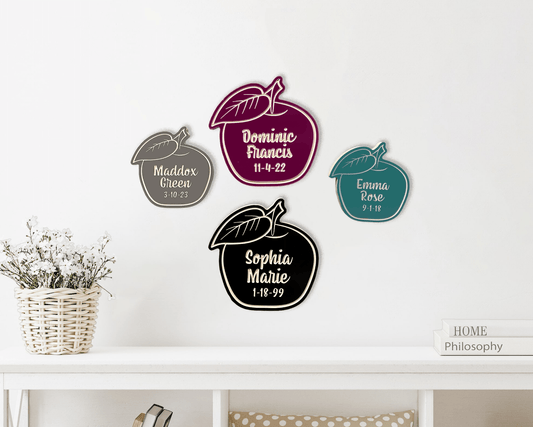 Apple of My Eye wooden apple design shown in standard and large sizes in burgundy, black, driftwood gray, and teal