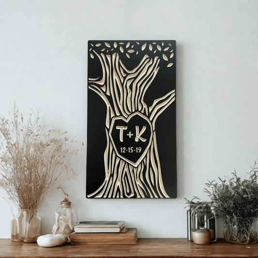 Decorative wall art with tree design and initials on a white wall above a wooden console table.