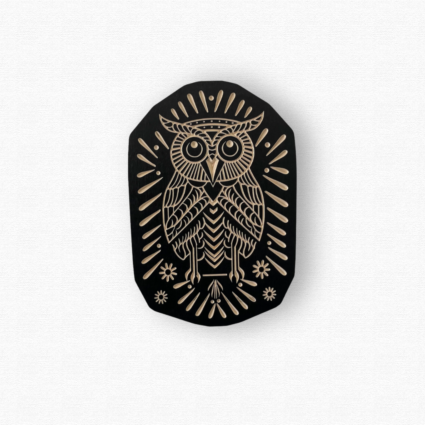 Black and birch wood owl design on a white background