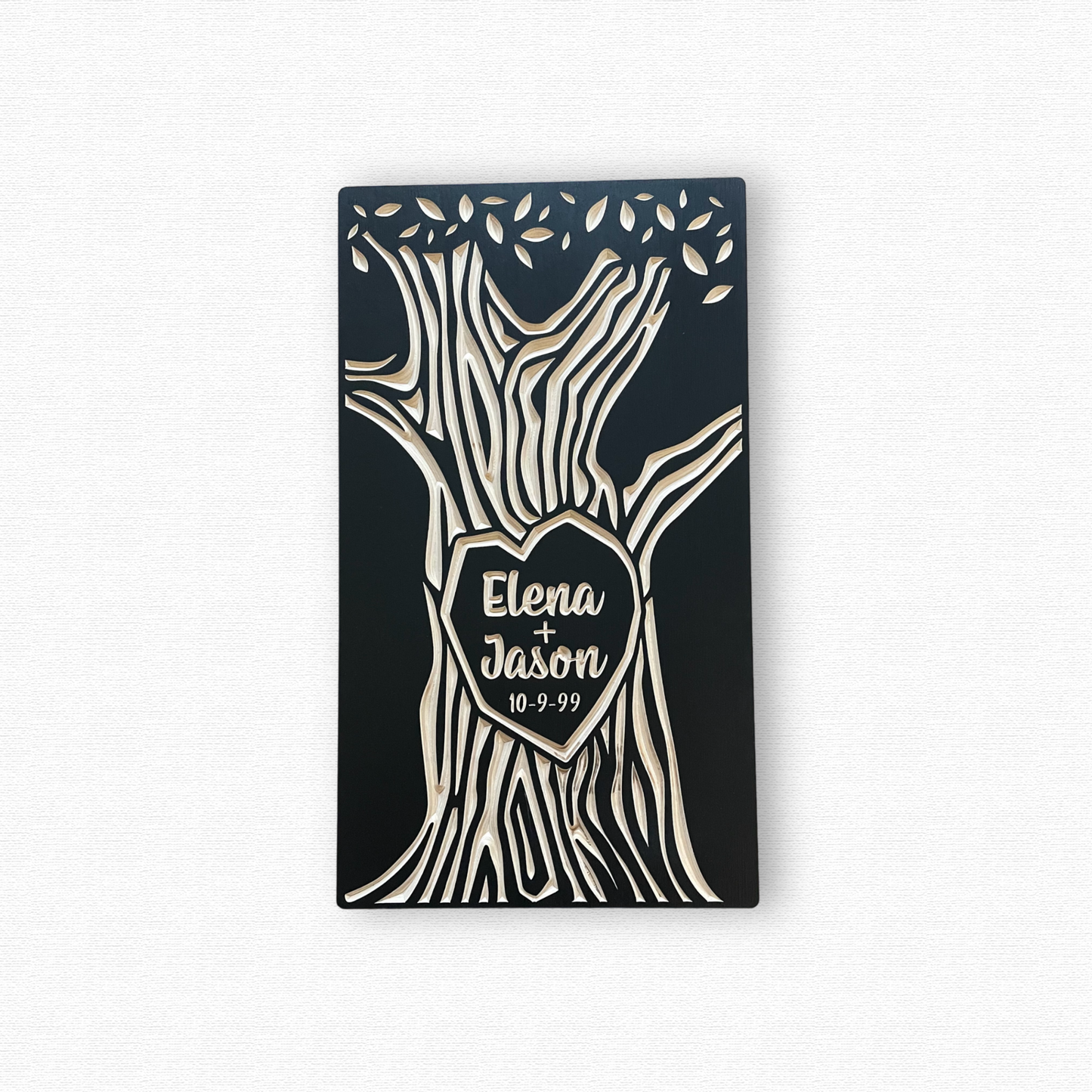 Decorative wall art with tree design and personalized text on a black background
