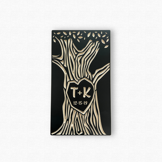 Decorative wall art with tree design, heart-shaped center, and initials 'T' and 'K' on a white background.