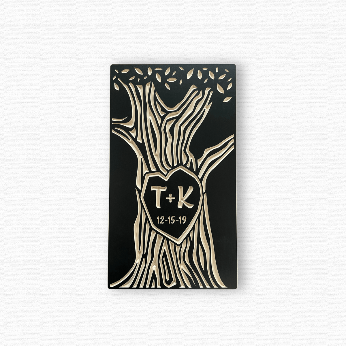 Decorative wall art with tree design, heart-shaped center, and initials 'T' and 'K' on a white background.