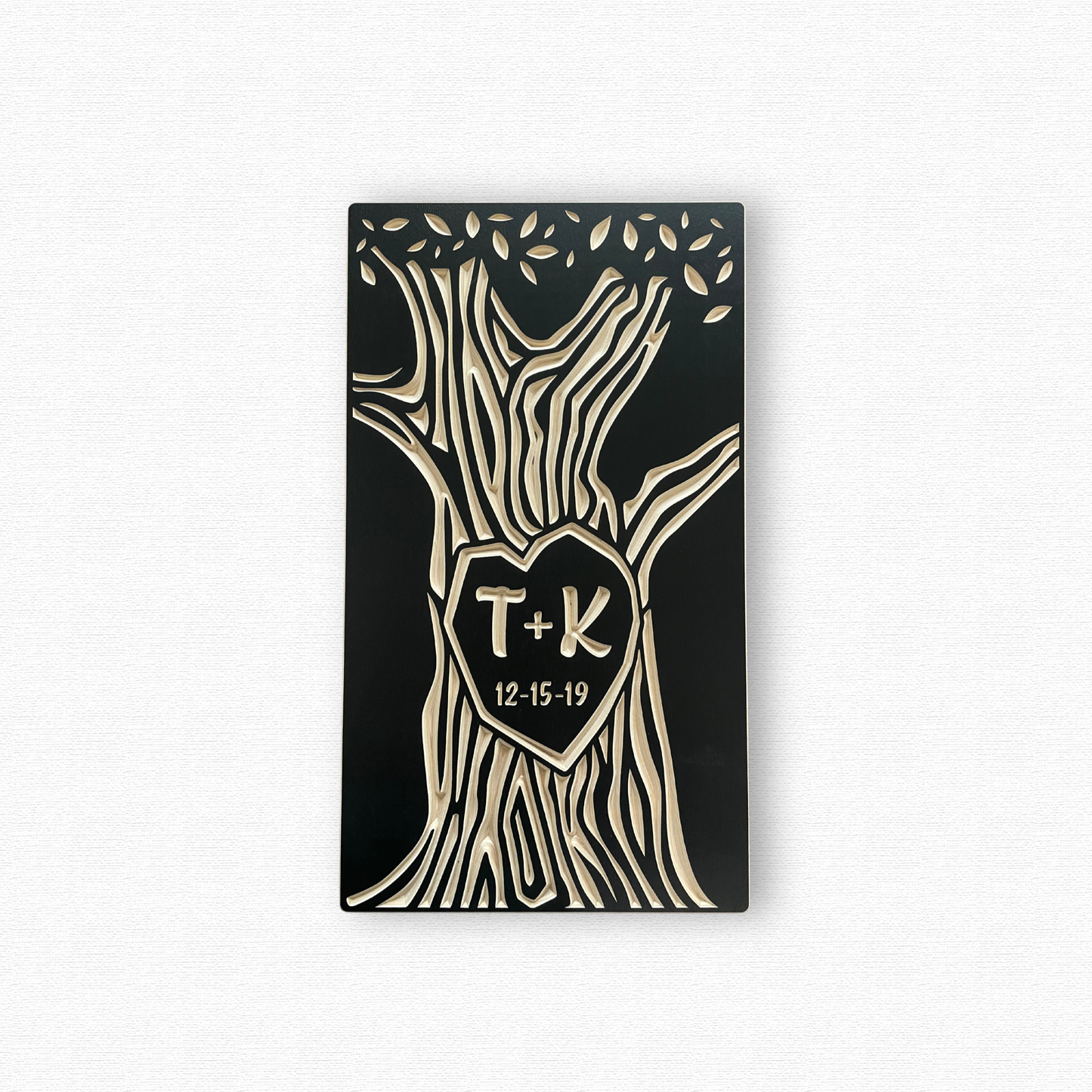 Decorative wall art with tree design, heart-shaped center, and initials 'T' and 'K' on a white background.