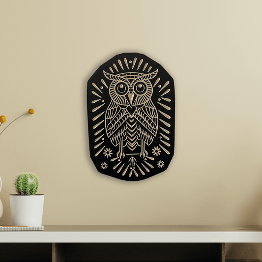 A wall-mounted owl carved from wood, with a black and white color scheme, surrounded by geometric patterns.