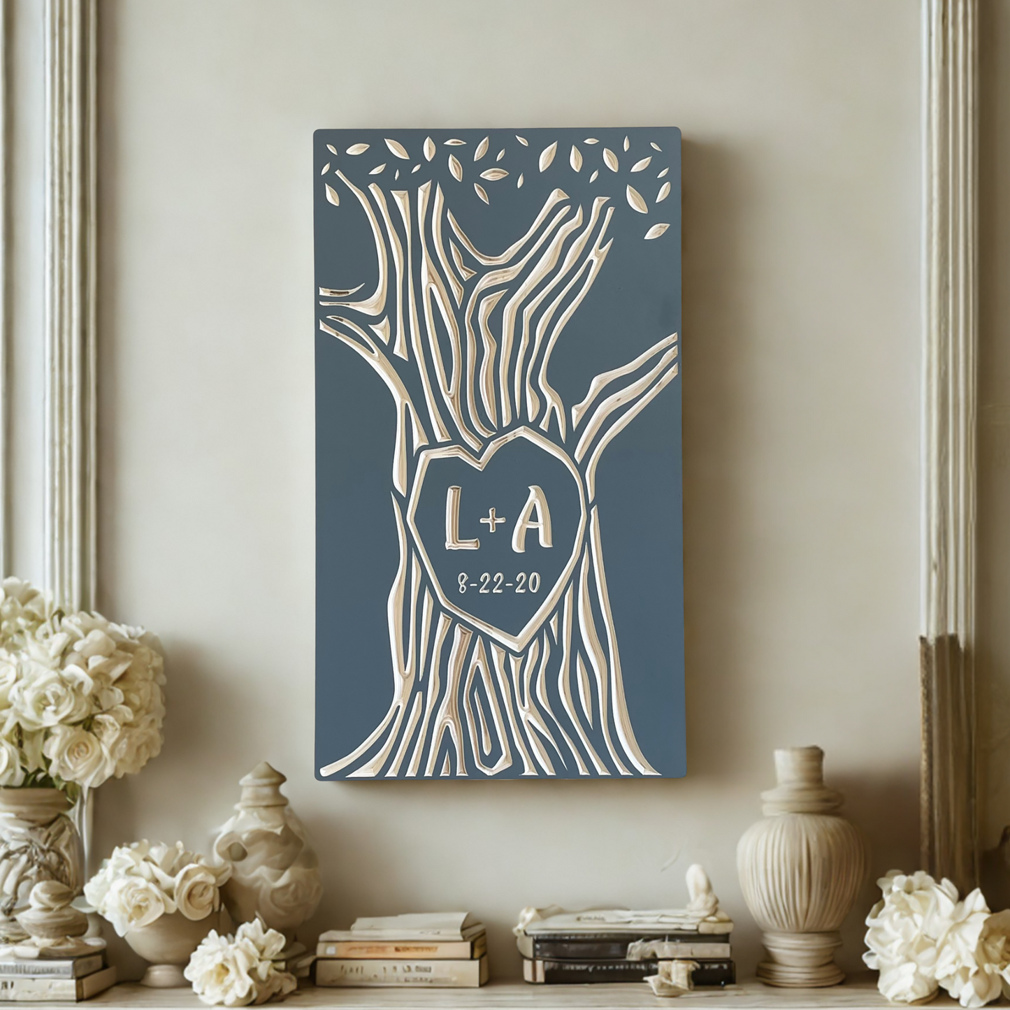 Decorative wall art with initials and date on a shelf with flowers and books.