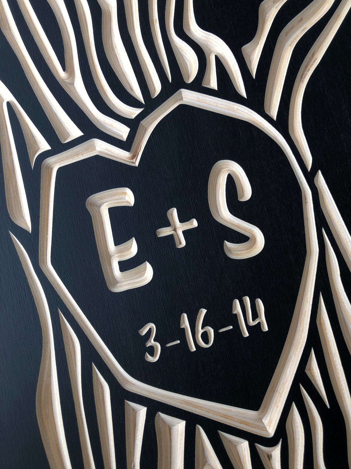 closeup view of custom carved tree with initials, black color option