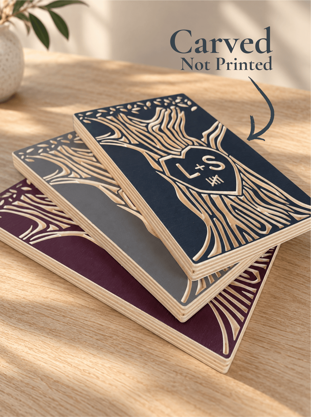 Three personalized Tally Tree anniversary wood signs in burgundy, navy and gray, featuring carved initials and anniversary tally marks.