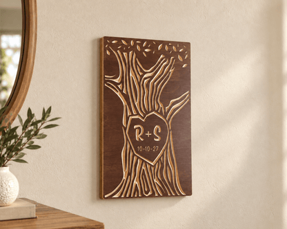 A personalized wooden wall art piece featuring a carved tree design with a heart-shaped center engraved with the initials 'R+S' and the date '10.10.27"