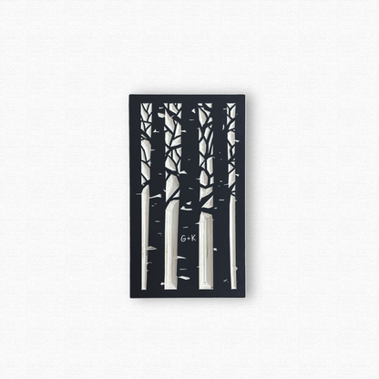 Decorative wooden wall art with black silhouettes of an aspen forest with a couple's initials carved in a trunk. Shown in black finish on white background.
