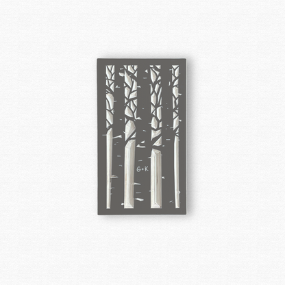 Decorative wooden wall art with black silhouettes of an aspen forest with a couple's initials carved in a trunk. Shown in taupe gray finish on white background.