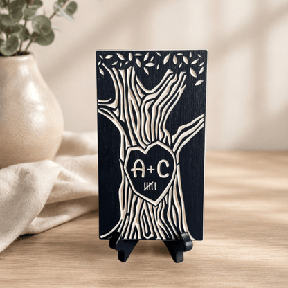 A personalized wooden tree plaque with a heart-shaped center containing the initials 'A+C' and 6 tally marks, displayed on a small black stand on a wooden table.