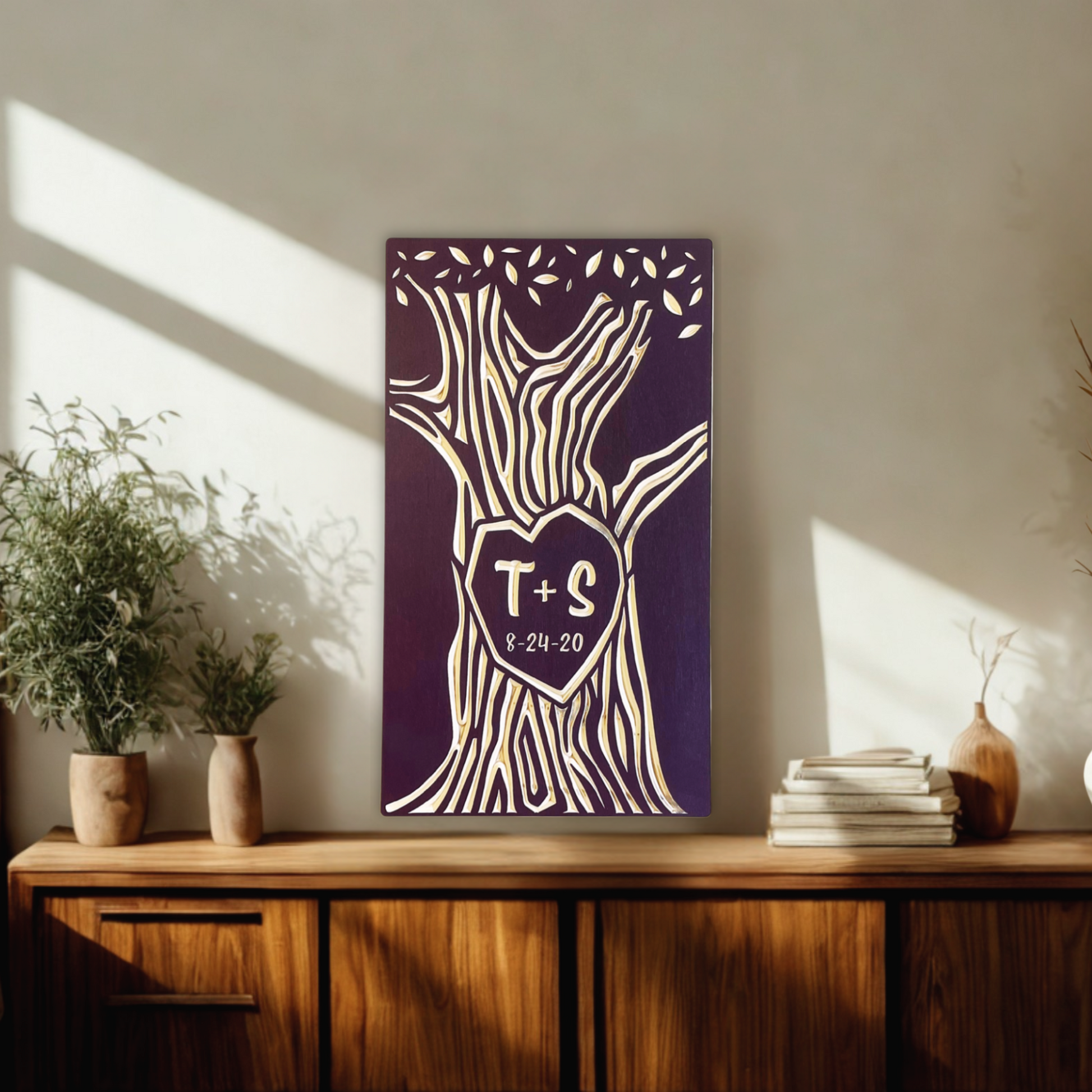 Decorative wall art with initials on a wooden console table in a sunlit room.