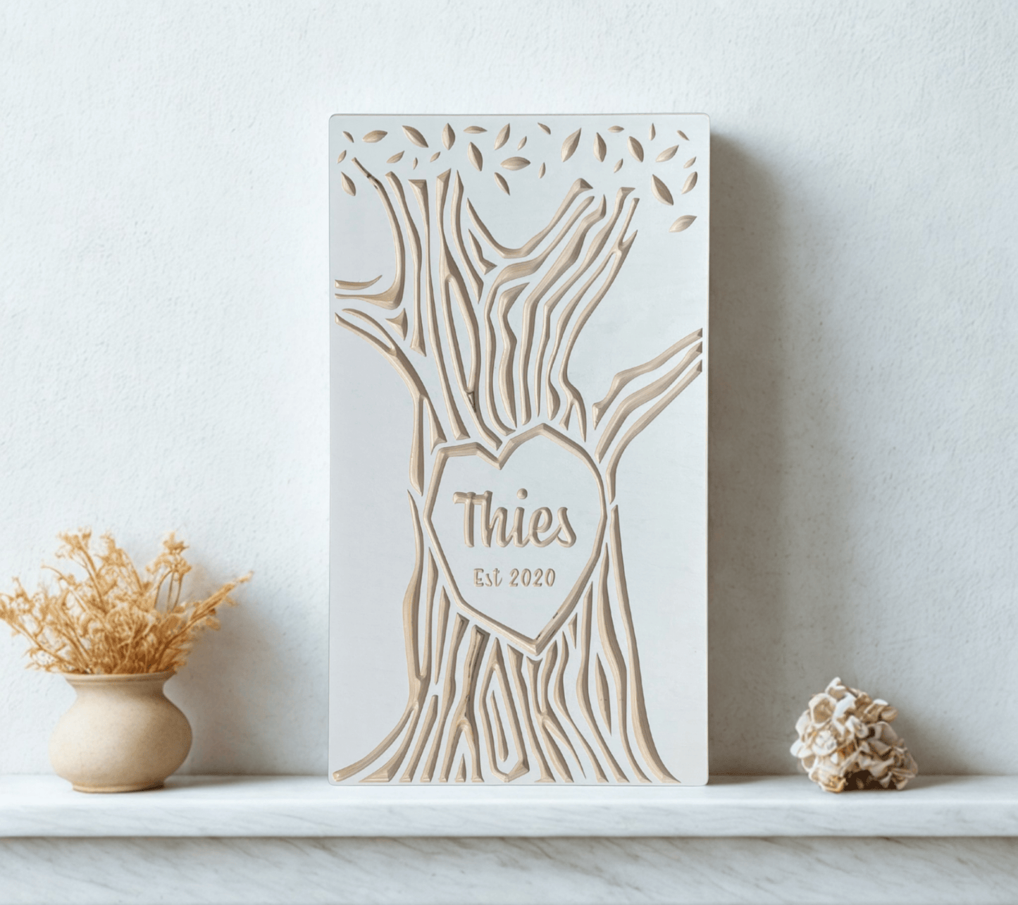Decorative wall art with tree design and last name on a white surface.