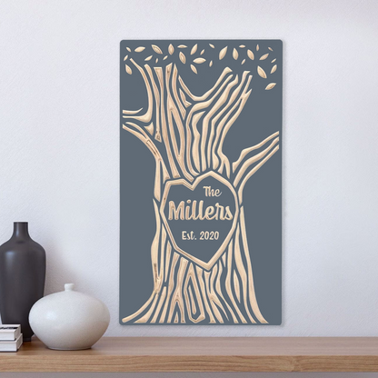Family last name carved into wood tree, gray finish