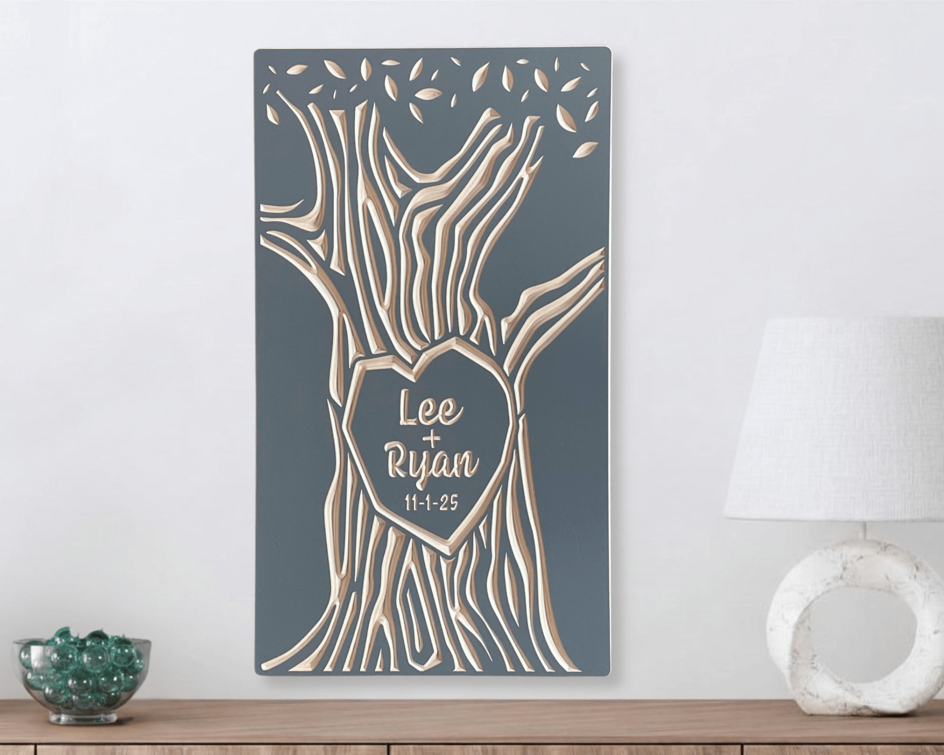 Wood wall art with tree design and personalized names on a gray background