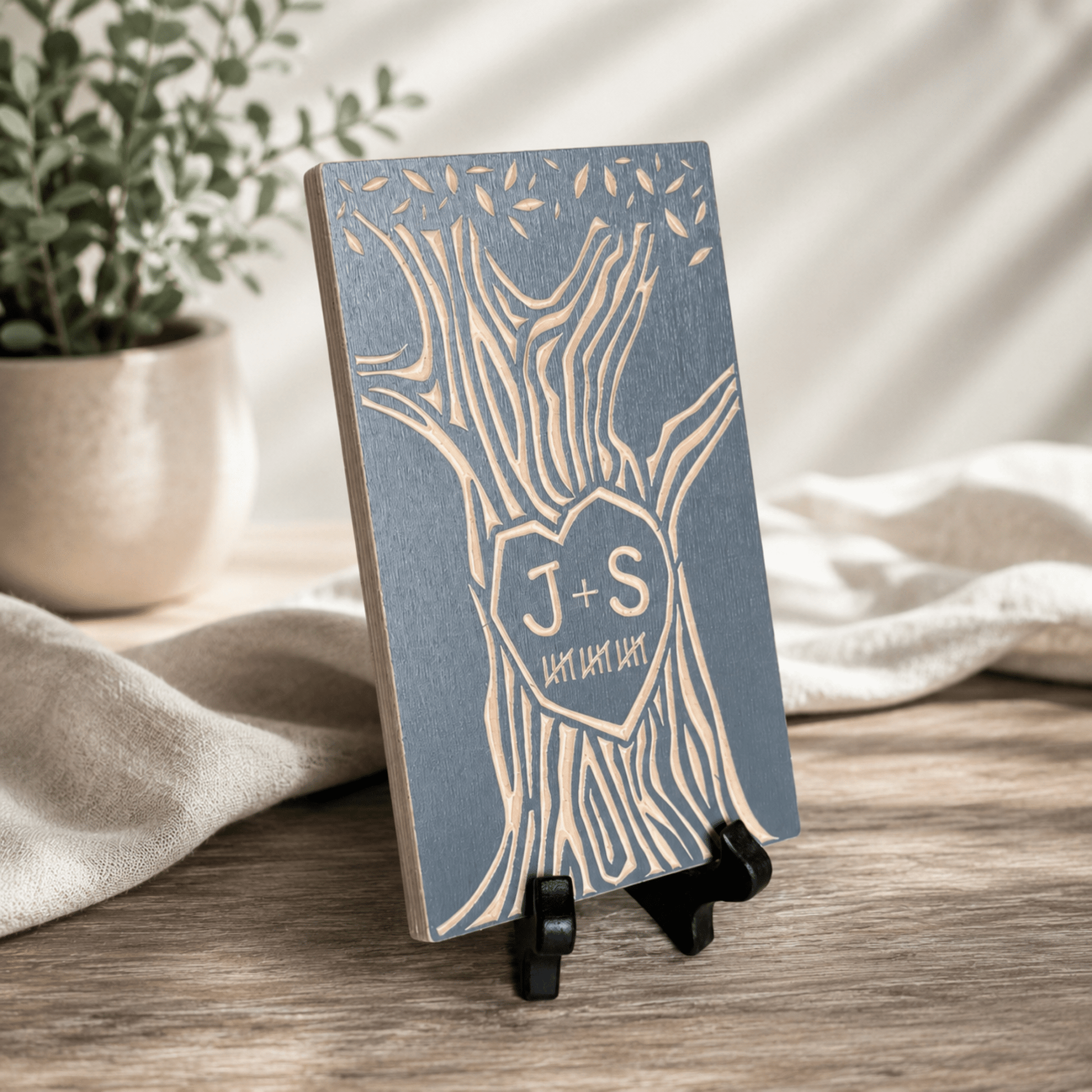 Small wood desktop sign shaped like a tree, gray finish, with two initials carved in the trunk and tally marks below representing years together. Compact size sits on a shelf or desk.