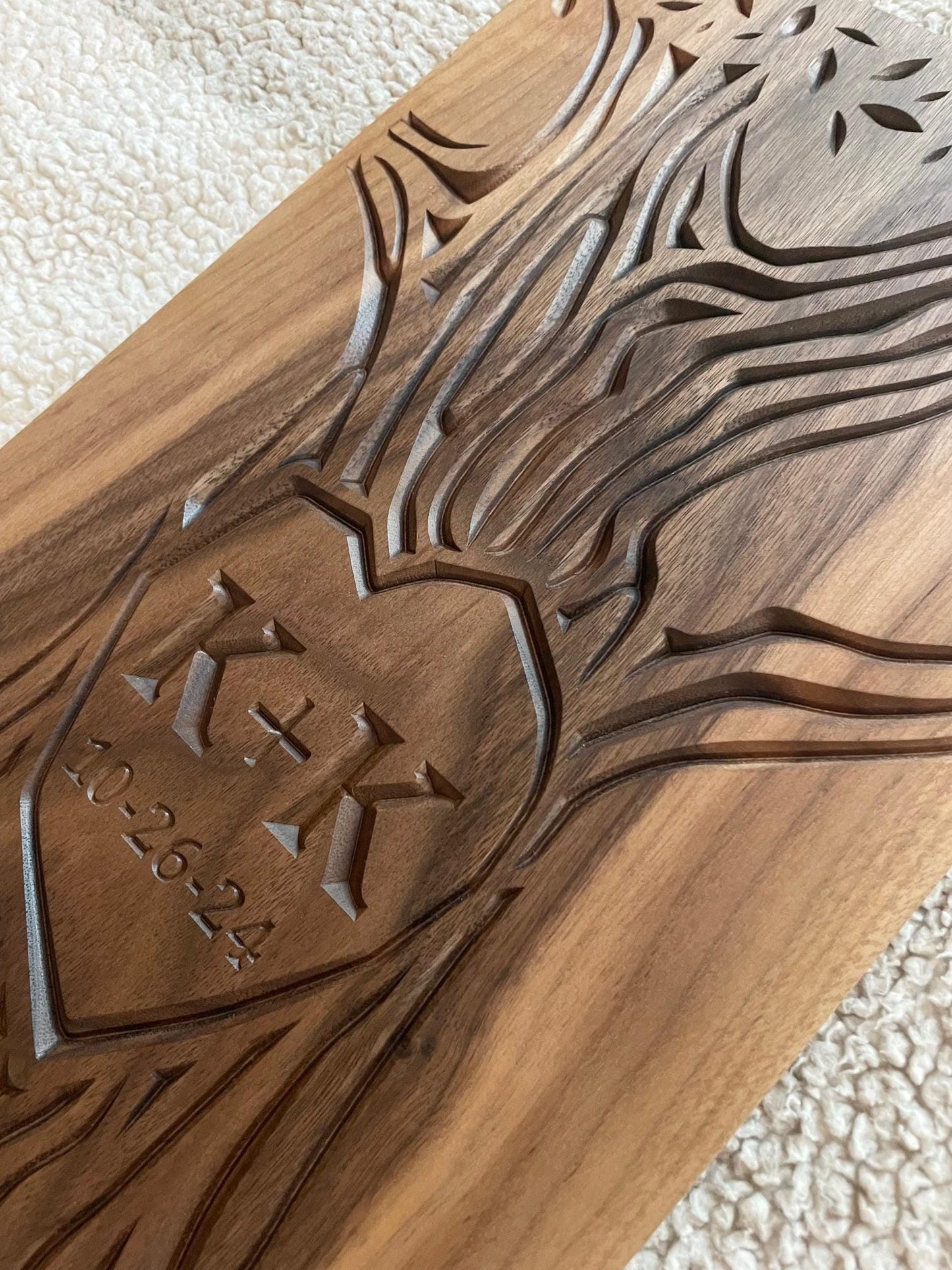 Another closeup view of carved wall art with initials and wedding date carved into the trunk of a tree design. Artwork is carved on a solid walnut wood panel