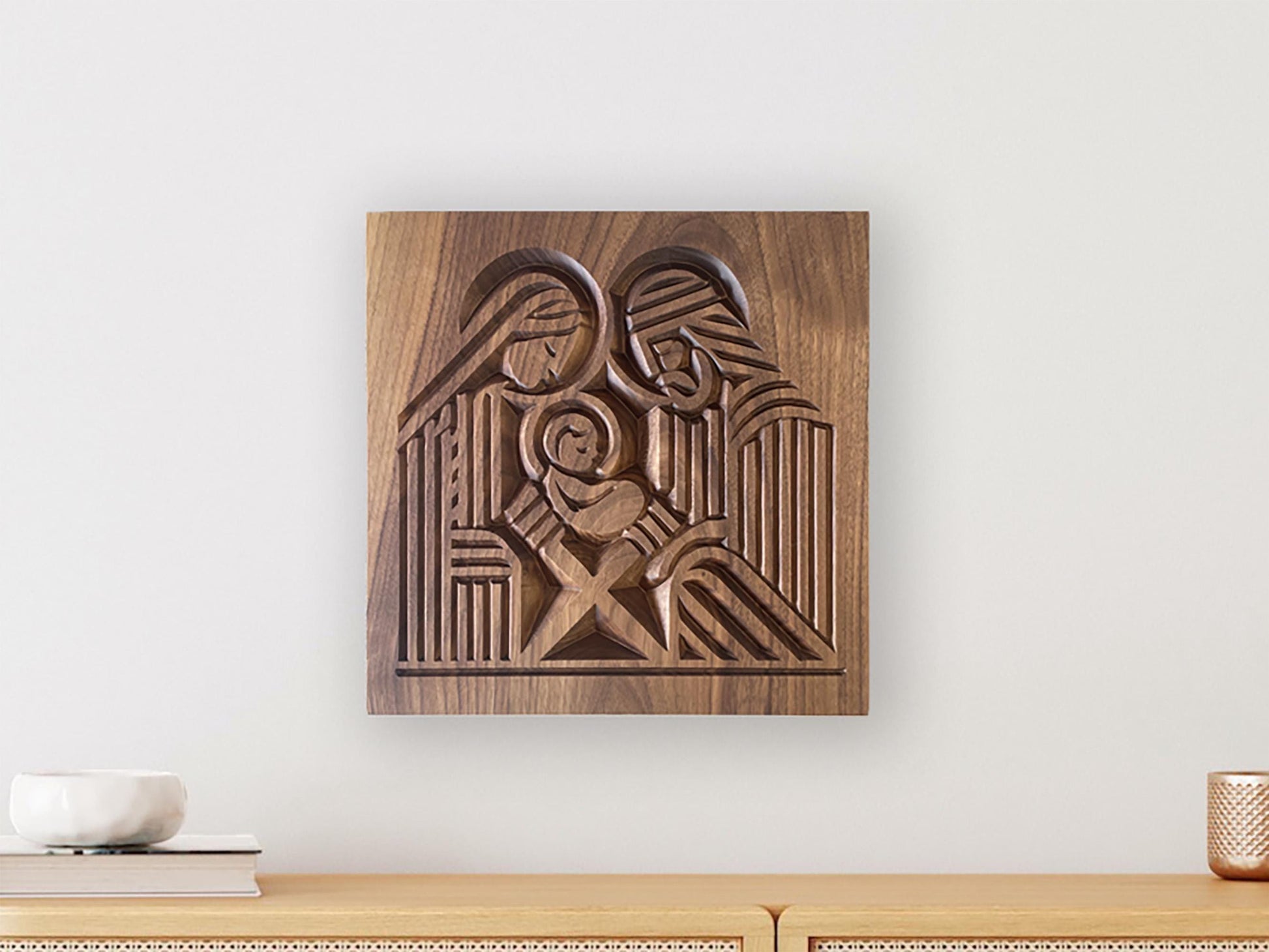 Wall hanging of Mary, Joseph, and infant Jesus carved block print style on walnut wood.