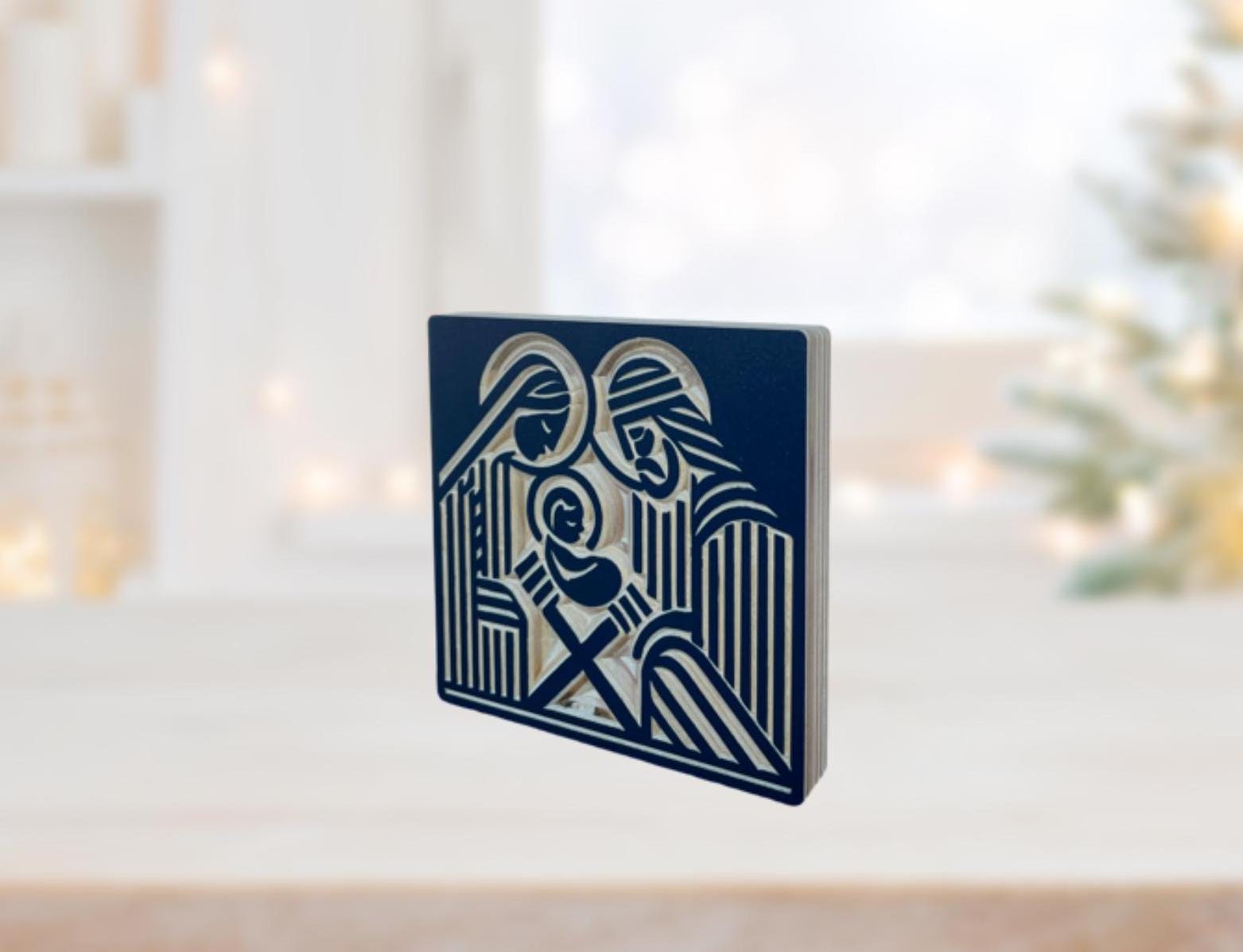 wooden nativity shelf decor with Joseph, Mary and the infant Jesus carved into baltic birch wood in a block print style. Shown in navy.