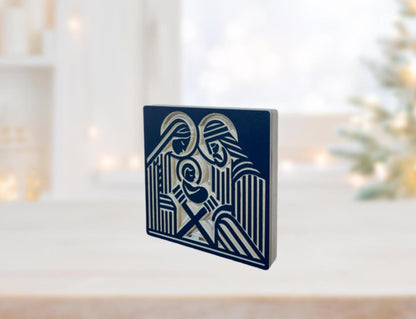 wooden nativity shelf decor with Joseph, Mary and the infant Jesus carved into baltic birch wood in a block print style. Shown in navy.