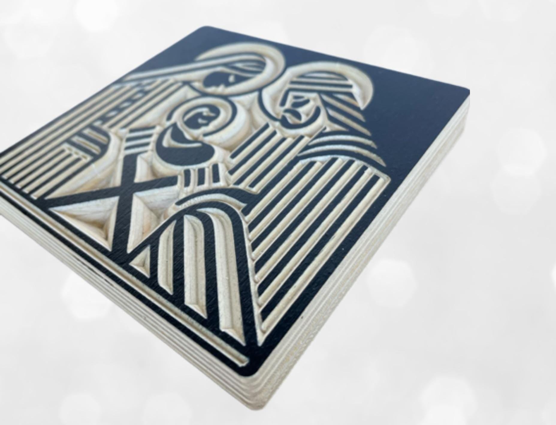 Side view of modern wooden nativity shelf decor with Joseph, Mary and the infant Jesus carved into baltic birch wood in a block print style. Shown in black.