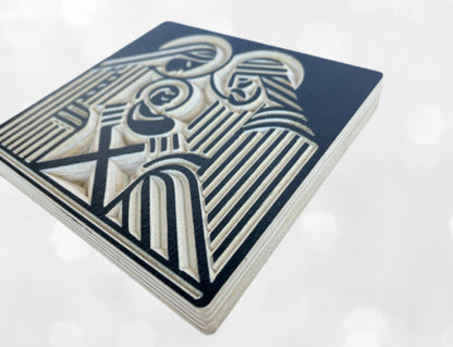 Side view of modern wooden nativity shelf decor with Joseph, Mary and the infant Jesus carved into baltic birch wood in a block print style. Shown in black.