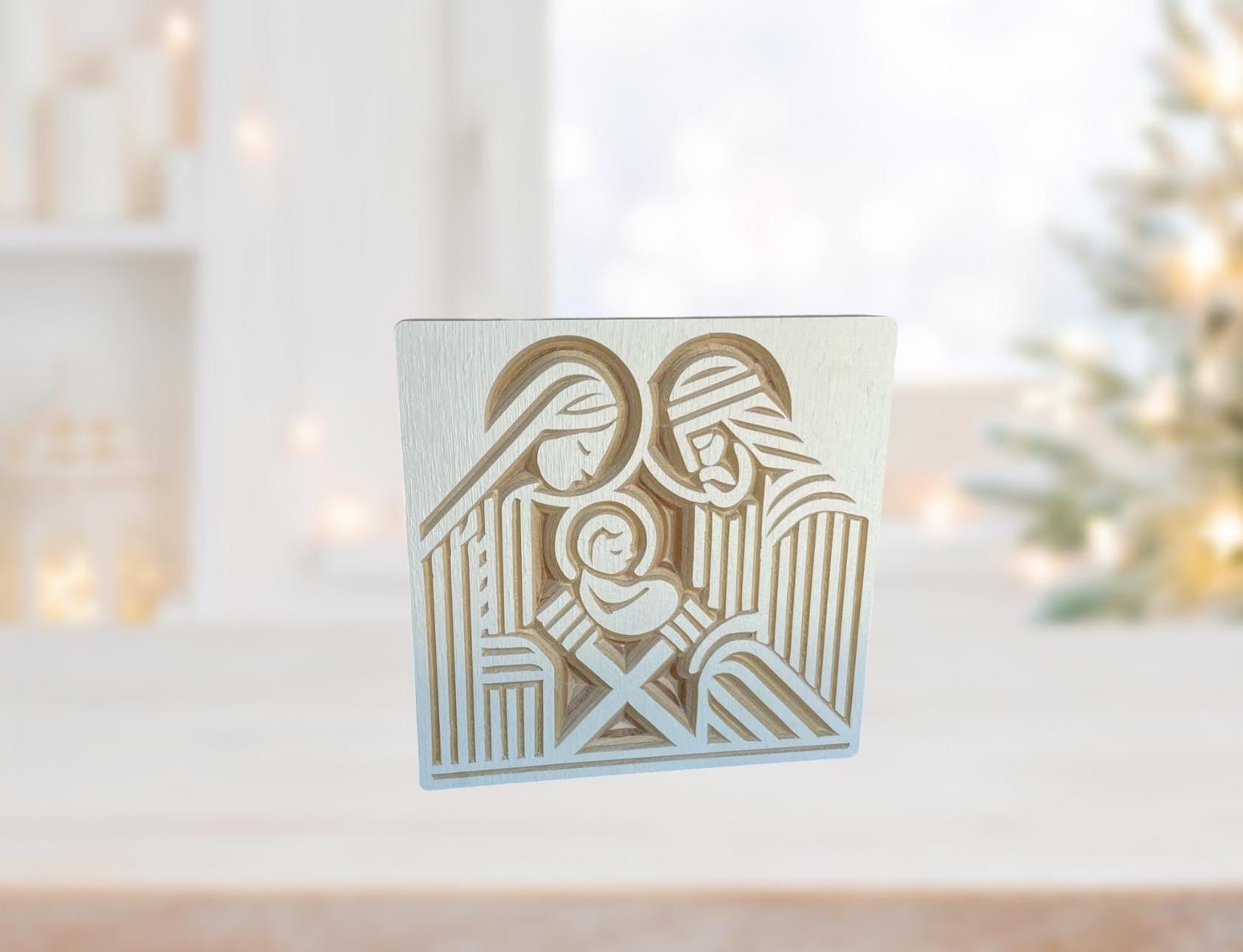 wooden nativity shelf decor with Joseph, Mary and the infant Jesus carved into baltic birch wood in a block print style. Shown in white.