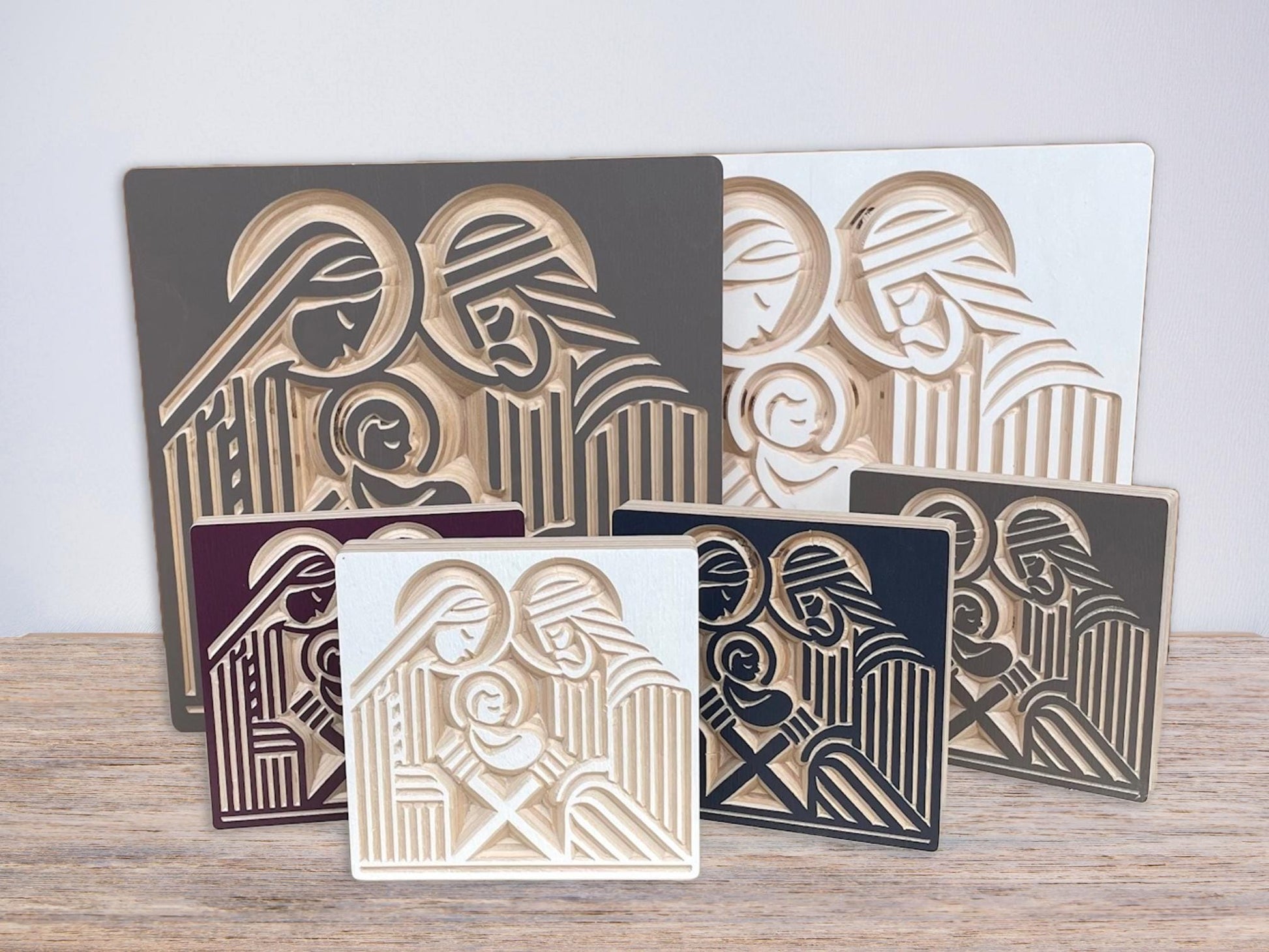 Wooden nativity mantle decor with Joseph, Mary and the infant Jesus carved into baltic birch wood in a block print style. Various size and color options.
