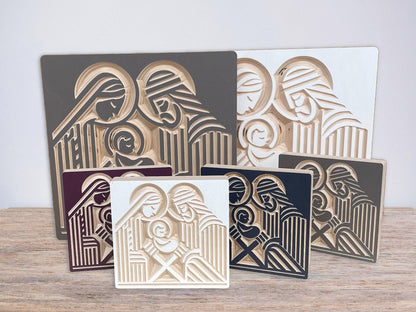 Wooden nativity mantle decor with Joseph, Mary and the infant Jesus carved into baltic birch wood in a block print style. Various size and color options.