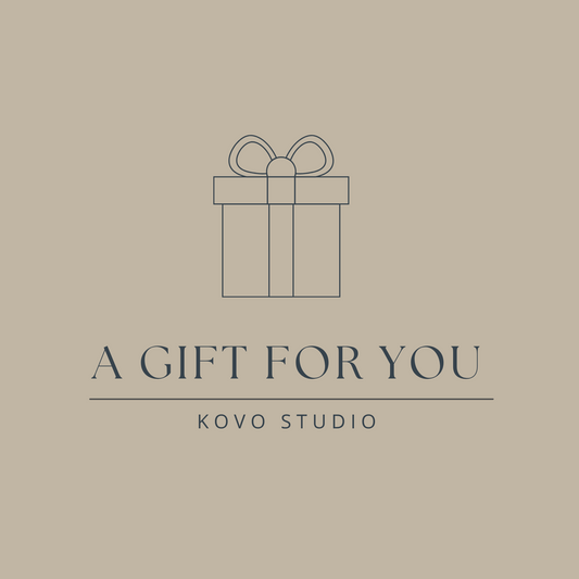 Gift box icon with 'A Gift For You' text and 'Kovo Studio' on a beige background