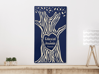 Decorative wall art with tree design and 'Edward + Jeannie Forever' text on a navy blue background, displayed hanging above a shelf.
