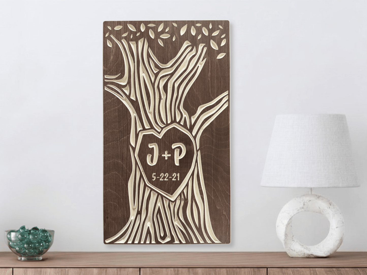 Wooden wall art with tree design and initials, shown in walnut stain on a white wall.