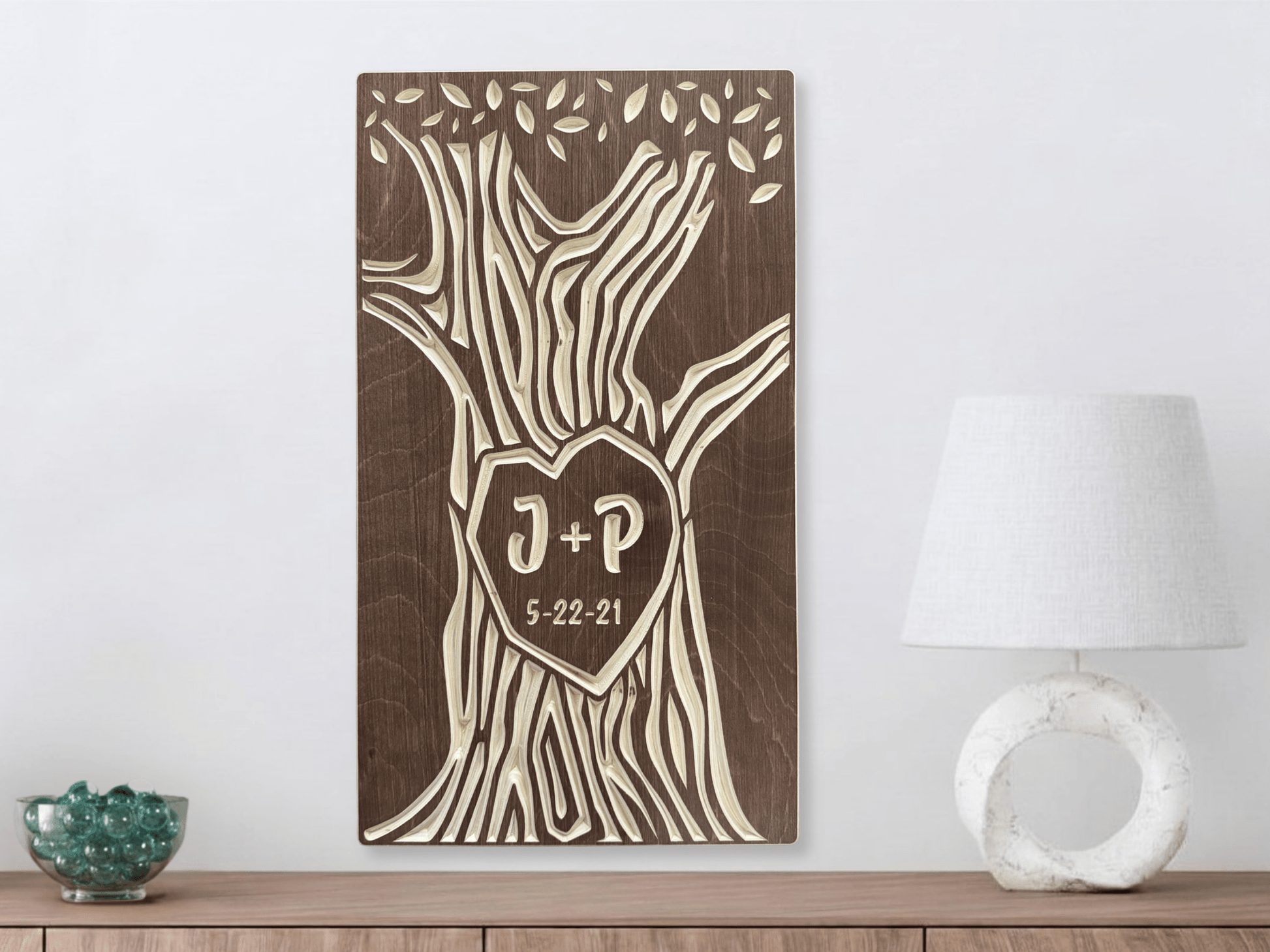 Wooden wall art with tree design and initials, shown in walnut stain on a white wall.