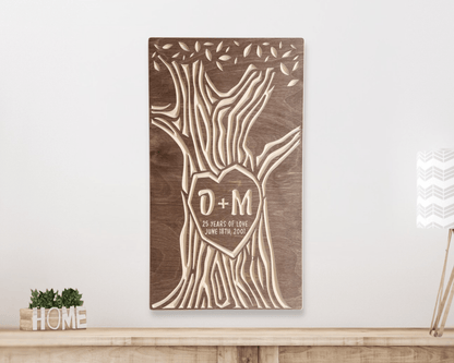 Wooden wall art with tree design customized with 25th anniversary text on a white wall.