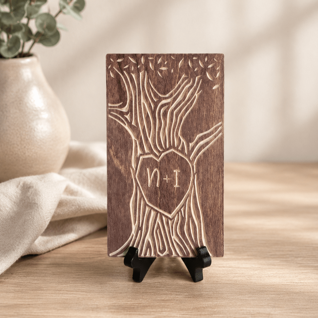 Tally mark tree sign displayed on a wood shelf next to  a small plant, showing how the compact plaque fits into home decor.